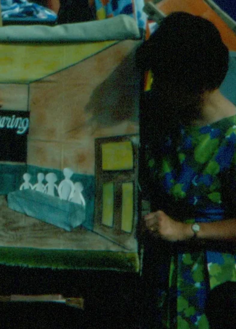 Image of a woman from the beach mission team on the beach doing flannelgraph storytelling