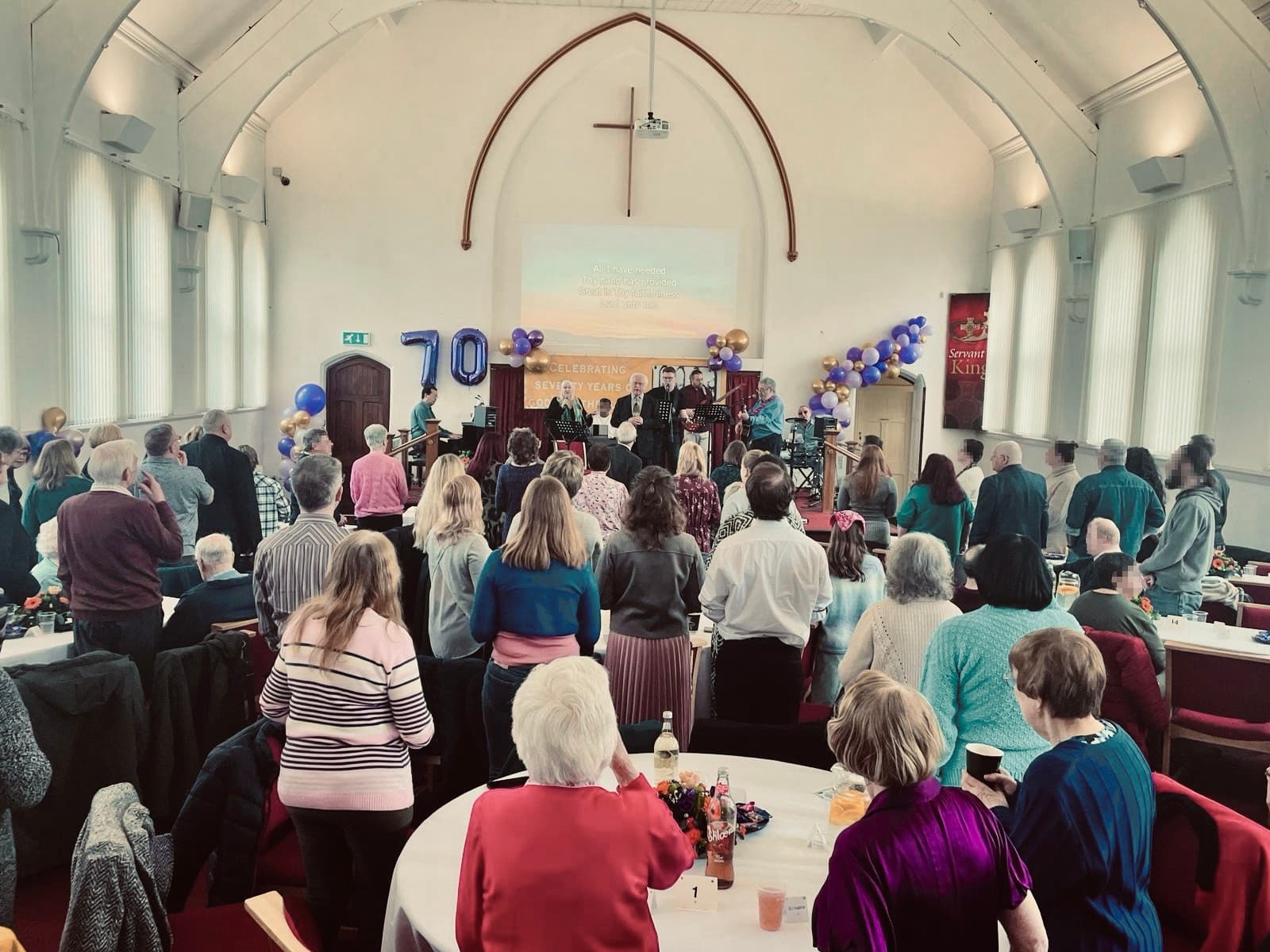 A diverse group of people from the church smiling together