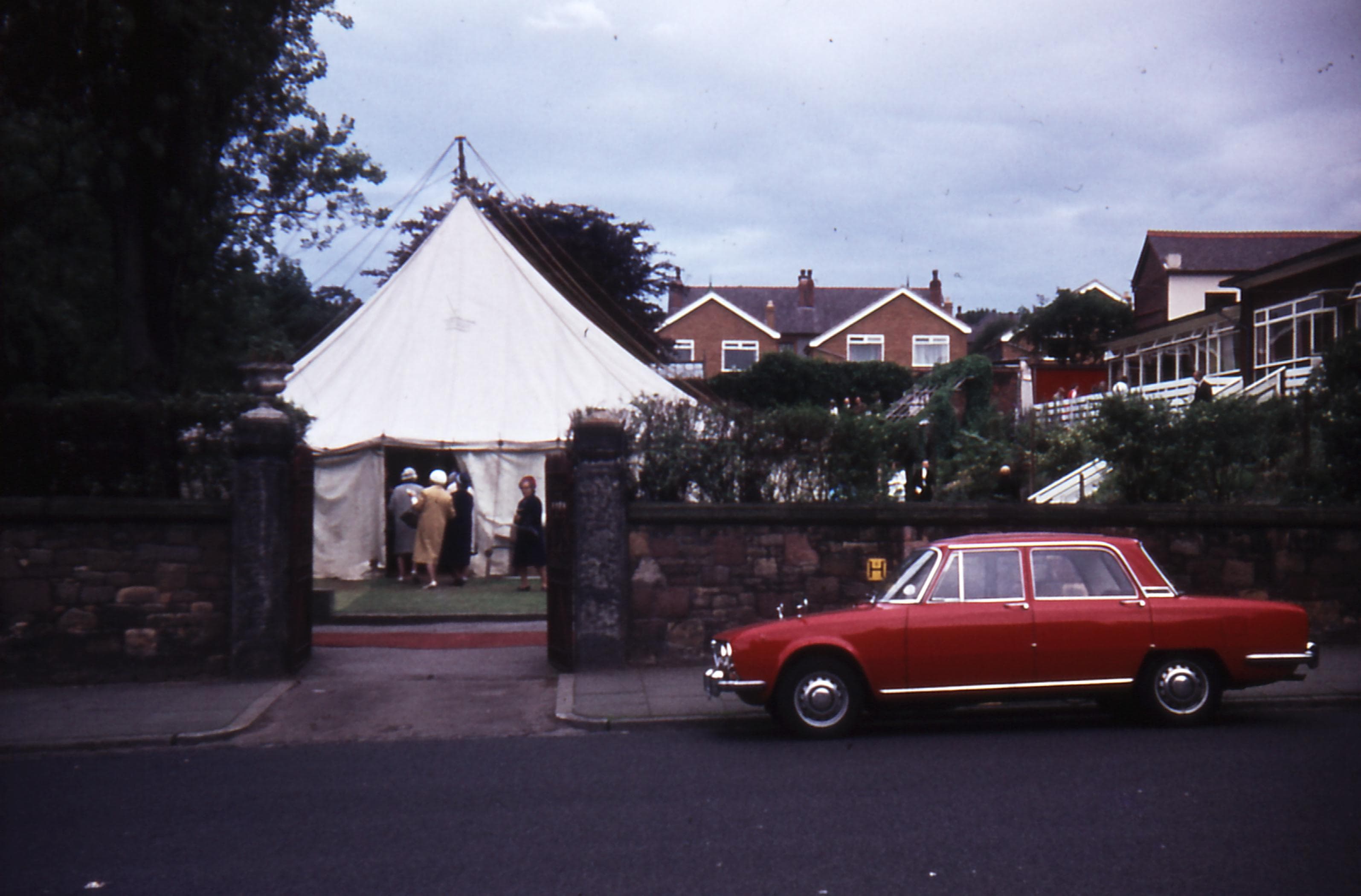 Image of Emmanuel Bible College from the gates on Park Road with the Missionary Convention Tent on the grass